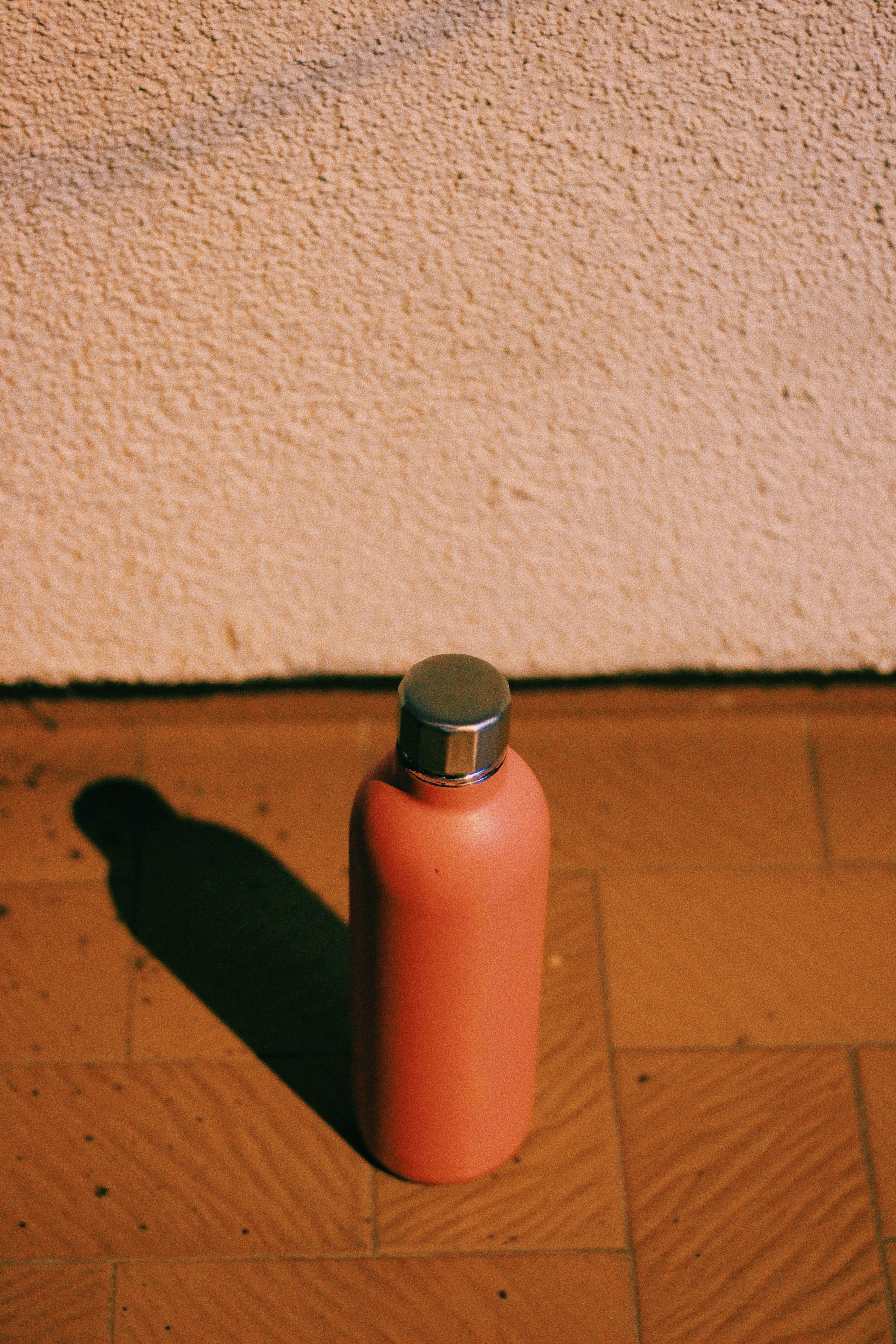 orange and silver tube bottle